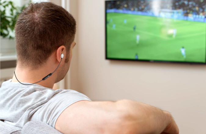 Man Watching TV using the TV Voice Pro